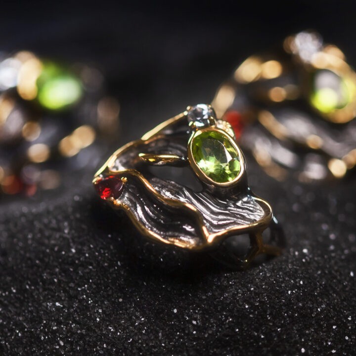 Athenas Peridot with White Topaz and Garnet Prosperity Ring